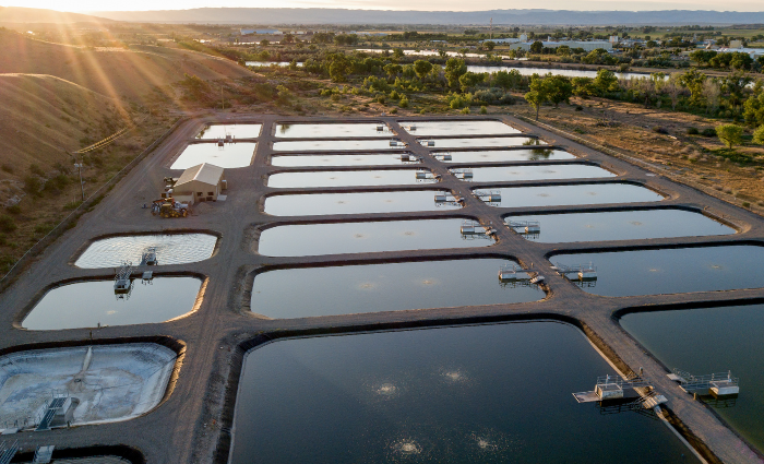 Aerial view of a wastewater treatment center with the Colorado rockies in the horizon